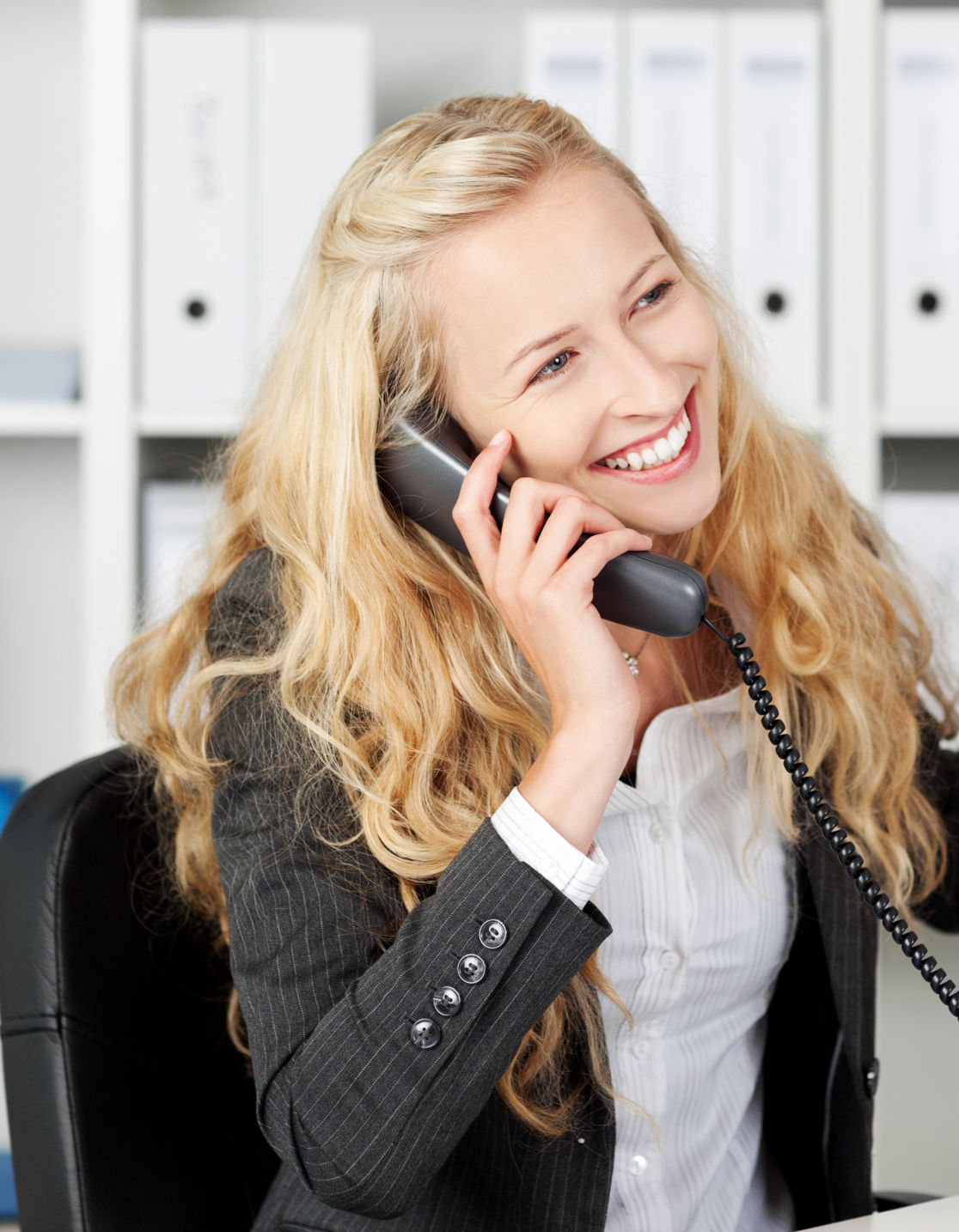 Young woman happily talking on the phone