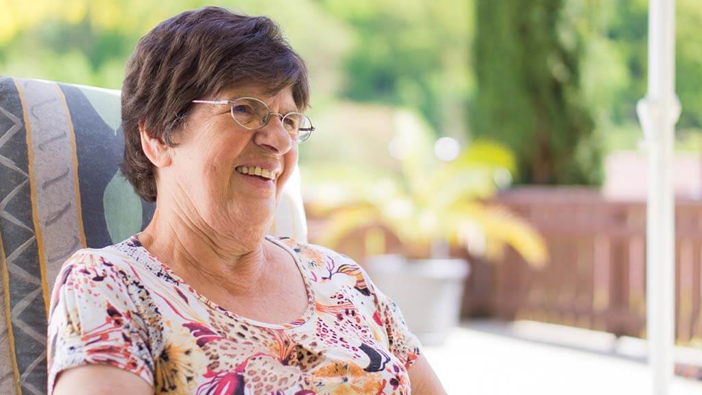 Smiling elderly woman outside