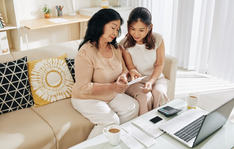Mother and Daughter looking at a bill